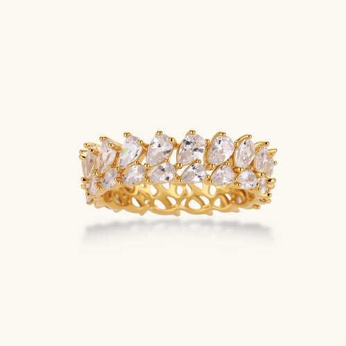 Adjustable gold-plated ring with double-row pear-shaped cubic zirconia stones in geometric pattern on cream background.